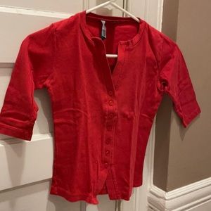 Moda International red top with 3/4 sleeves.